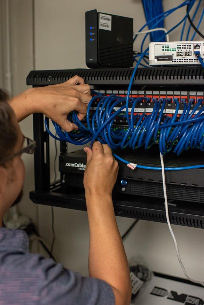 Close up of an Ascend associate working with wires at a Friendship Community Care Location