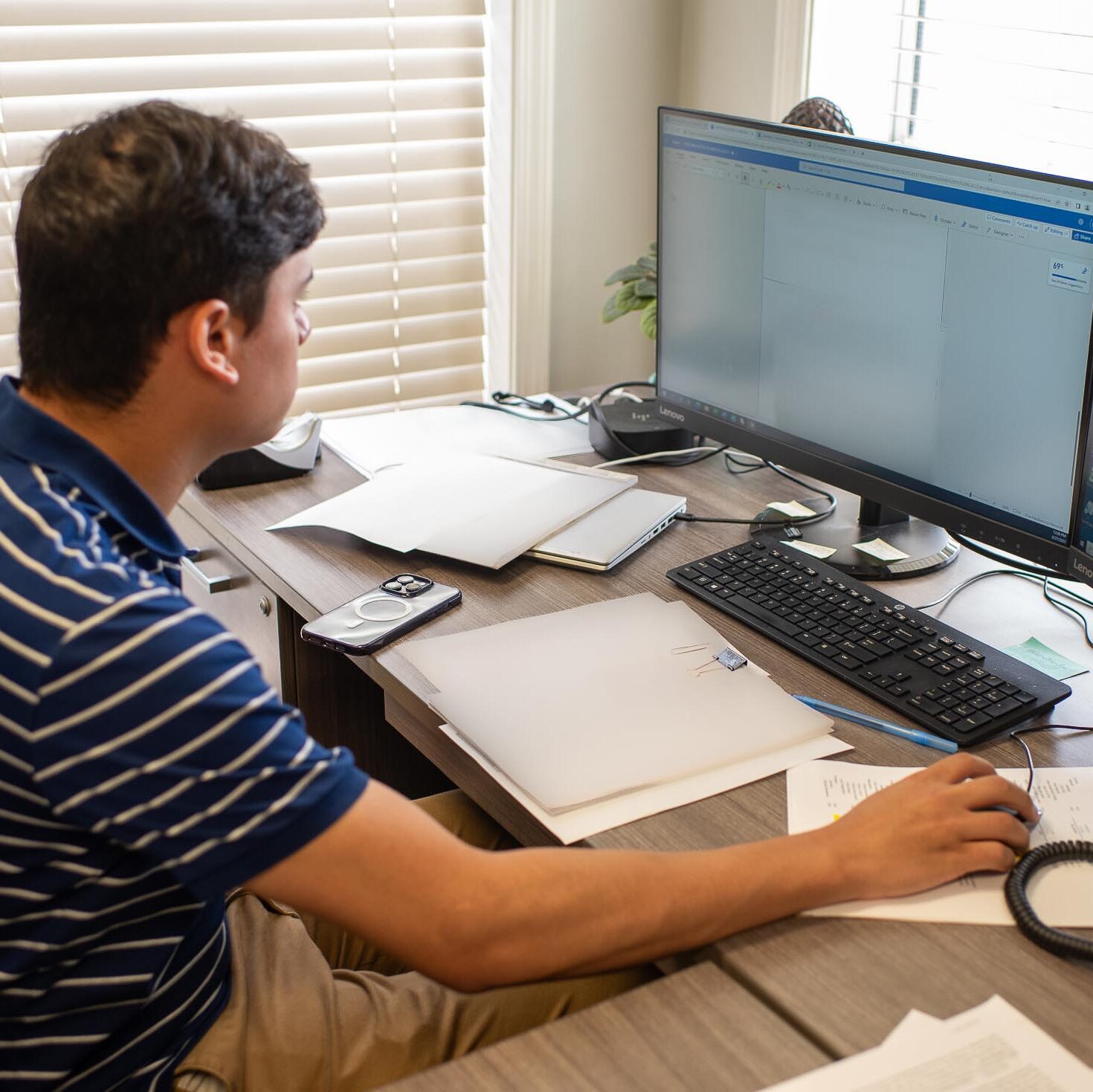 Photograph of a Friendship Community Care Edafio Associate working on their computer